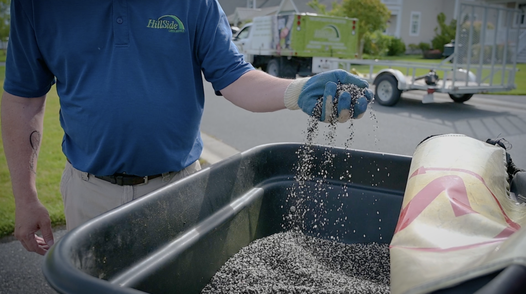 hillside technician with hands in fertilizing nutrients